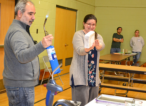 Felipe Menanteau and Pena Martin prepare to do a blowtorch demonstration about high-temperature-proof materials used in space shuttles.