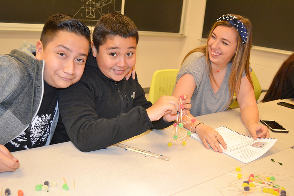 ChiS&E seventh graders work on a toothpick-gumdrop structure.