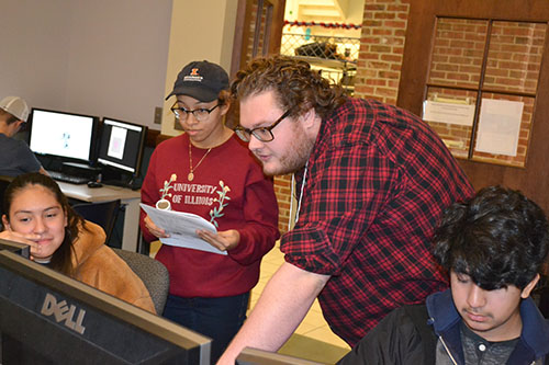 Will Helgren/Ochal (third from the left) works with an eighth grader during the Computer Science activity.
