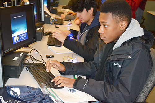 ChiS&E eighth graders use Python to program an LED Gemma board.