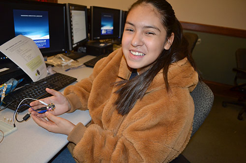  Whitney eighth grader Quiriat Ortiz shows off the circuit she made then programmed.