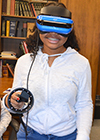 A Franklin student experiences virtual reality during the students' visit to MRL.
