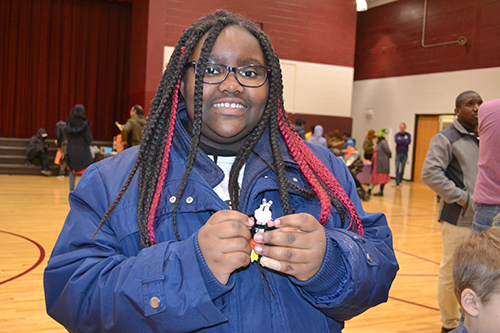 An M. L. King student works on a hands-on activity at the electrical engineering table.