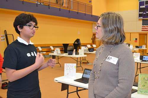 Psychology Professor Kara Federmeier listens as an NGS students presents his research project. </div>
