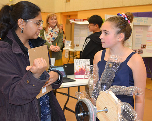 A Department of Cell and developmental biology graduate student Janhavi Kolhe interacts with an NGS student about her project.