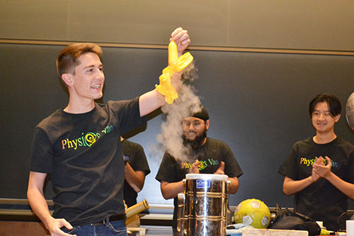 A Physics Van volunteer shows the visitors how a balloon animal immersed into a vat of liquid nitrogen shrivels up because the air molecules inside the balloons have condensed, then expands again as it reaches room temberature.