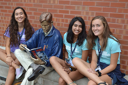 Berat Gulecyuz (left) and a few of her freshman mentees take a break by Grainger Bob by the south entrance to the Grainger Library.