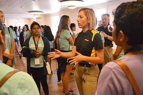 During the Company Fair during the resource tour, a representative from one of WIE's sponsors, Caterpillar, shares with freshmen about their company and what they're looking for in recruits.