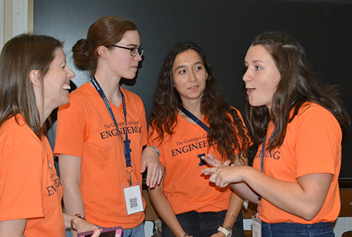 Michelle McCord (right), chats with several fellow WIE Orientation coordinators prior to the Wednesday night event.