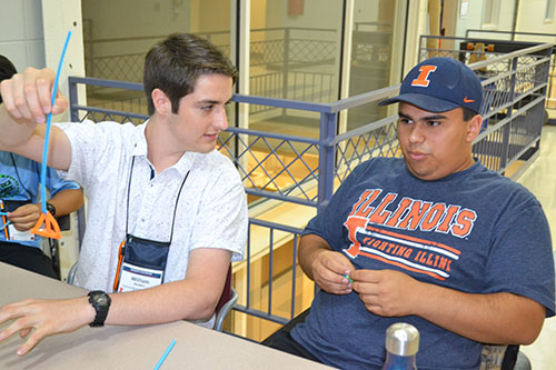 Two students at WYSE camp discuss the merits of the bubble wand one created.