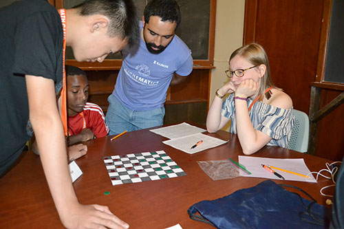 On the final day of camp, campers were allowed to pick whichever games they wanted to play on various sufaces. Here, they're playing  checkers on a 