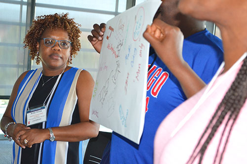 Anita Alicea, the STEM Initiatives Program Manager at the Sarah E Goode STEM Academy presents her team’s poster about student perceptions of what STEM is.