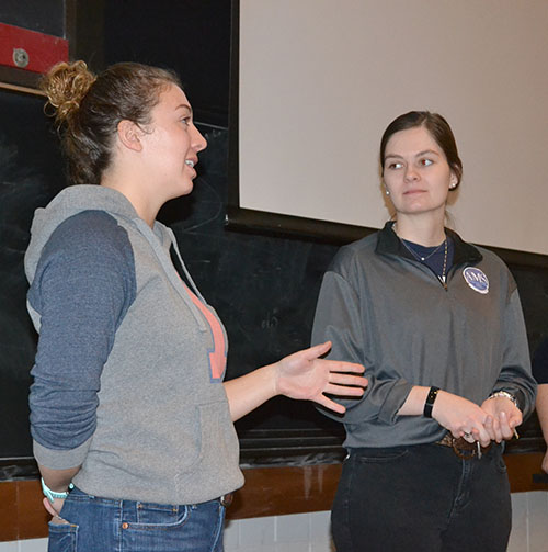 Justine Paul and Suzanne Peterson of AMS' Sottos Group explain their research to  the ChiS&E visitors.