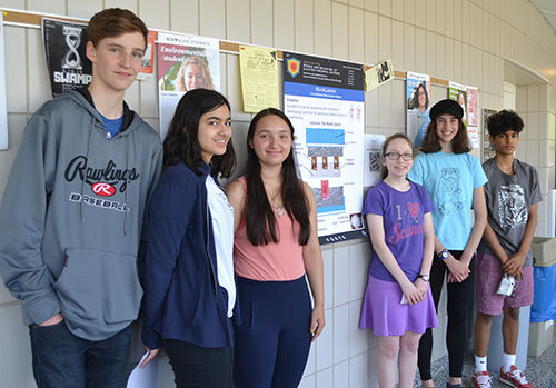 The BlankCubator team by their  poster.