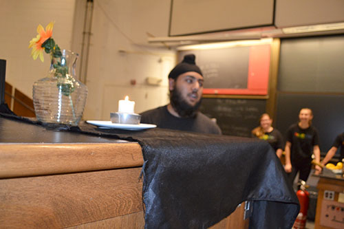 Above: Physics Van Co-Coordinator Japneet Singh has a table set with a flower vase and burning candle.