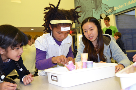 Yang Han works with two BTW students on a project automating a hot chocolate mixing design.