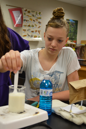 Contestant stirs her team's milk for the "Say Cheese" challenge.