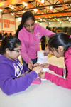 Betabrain contestants work to build a tower that will successfully hold up a brick.