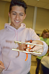 A high schooler shows off the device he and hs teammate created.