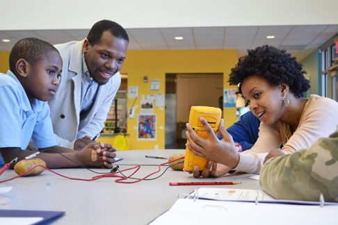 Left to right: A BTW student, Jerrod Henderson, and Lonna Edwards measure the voltage of a "potato battery" the student made during the Brady STEM Academy.