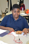 A BTW student makes a "potato battery" during the Brady STEM Academy after-school program.
