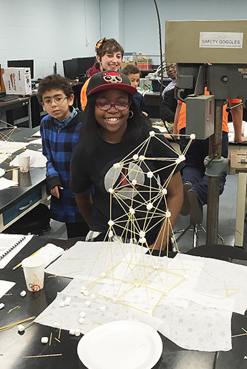  A student proudly displays the marshmallow-spaghetti structure she built during one of the fall 2015 workshops. (photo by Kevin Pitts) 