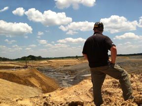 Miner views surface coal mine in southern Illinois.