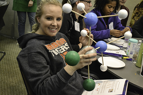 A UHS student shows off her team's molecular structure.