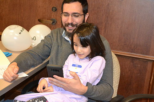 Seven-year-old Ginny and her dad playing the Kahoot website learning game.