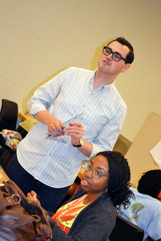 Kevin Erickson teaches a student an old archectect's trick: Taping pennies on the underside of a protractor helps it slide across other materials when drawing.