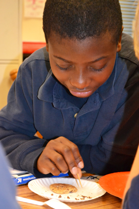 Fourth-grader learns about engineering while "mining" chips from a chocolate chip cookie.