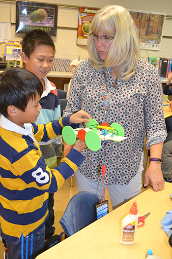 Dr. Howard 4th grade teacher, Jennifer Simmons speaks with students about their solar cars they built.