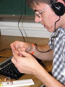 ECE student working on electronic trip wire.