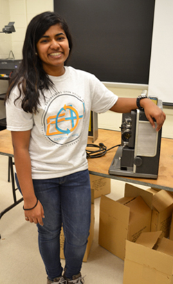 Illinois student Niranjana Sreekumar poses by her EOH exhibit, an old-style movie projector.