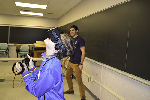 Local 10-year-old William Johnson experiences virtual reality, which allows him to find out what atoms moving around look like.