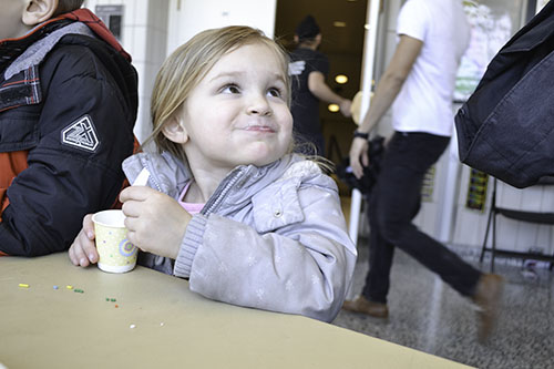 A young participant enjoys whipped cream...with sprinkles that she made.