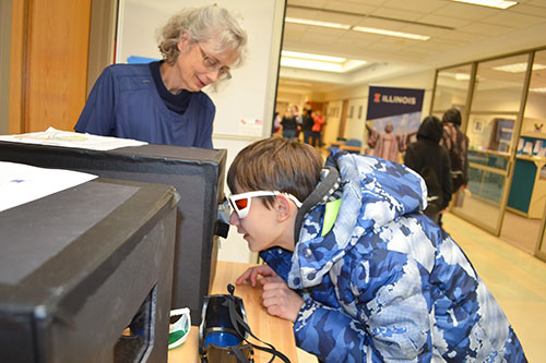 A young visitor experiences fluorescence at the  MRL Open House.