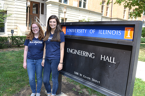 Co-coordinators, Elizabeth Sanders (right) and Siobhan Fox (left) in front of the Engineering Hall sign.
