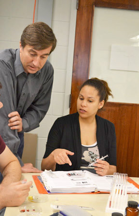 Joe Muskin works with an EnLiST teacher during a workshop of gold and silver nanoparticles.