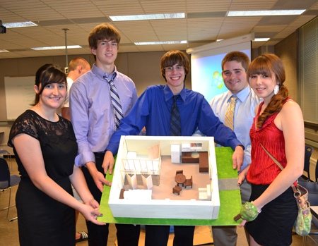 Micro House team displays model of house they designed.