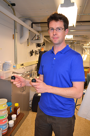 Randy Ewoldt holding two balls made of non-Newtonian substances