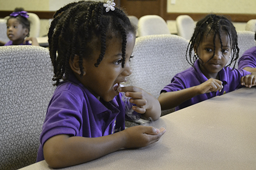 a young student tastes a marshmallow quick frozen in liquid nitrogen