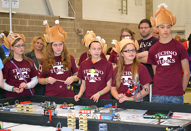TechnoTurks listen to the judge while competing at the FLL.