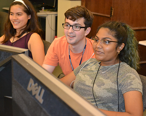 A MechSE student (center) works with GBAM GAMES campers learning CAD (computer-aided design)