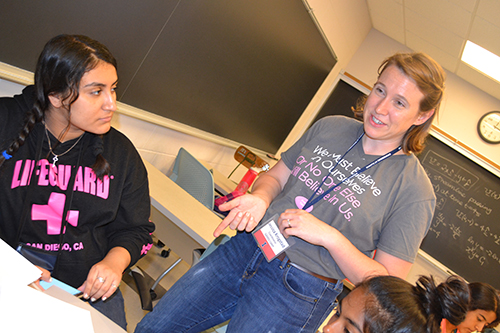 Jessica Krogstad chats with GLAM campers working on their design project.