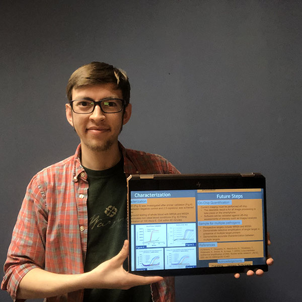 BioEngineering junior John Heredia shows off his ISUR Expo presentation.