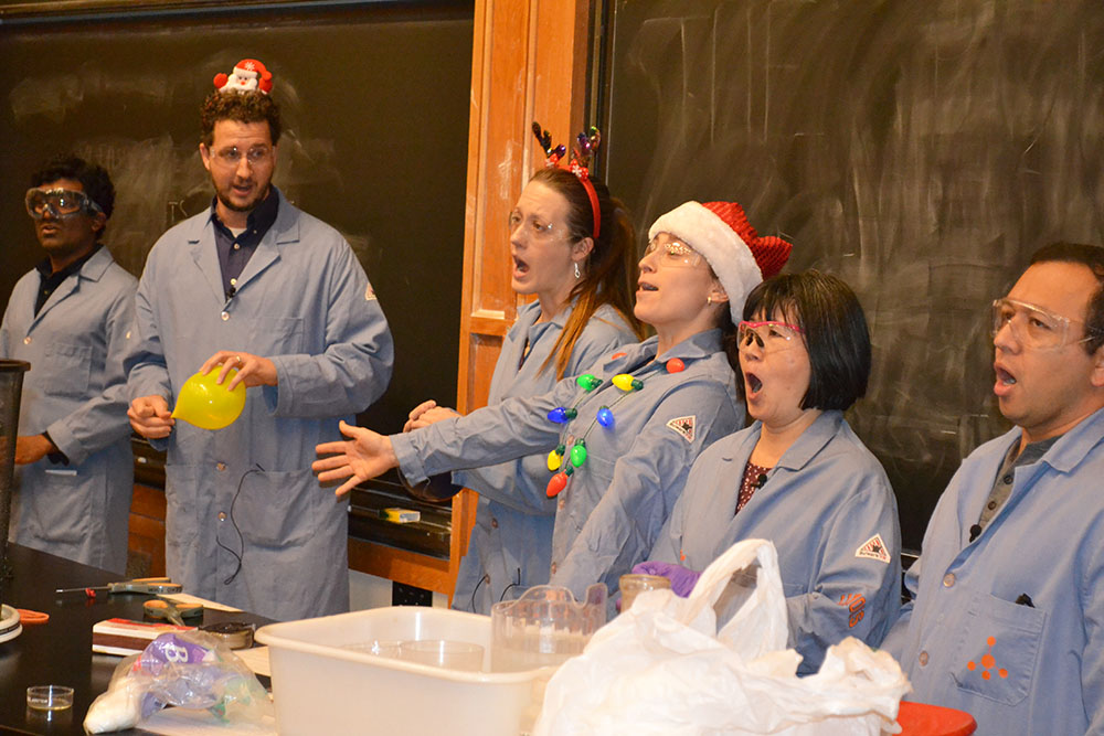 everal of Chemistry's teaching faculty, Mutha Gunasekera, Christian Ray, Elise McCarren, Jordan Axelson, Tina Huang, and José Andino perform the opening number for the 2019 Holiday Magic Show.