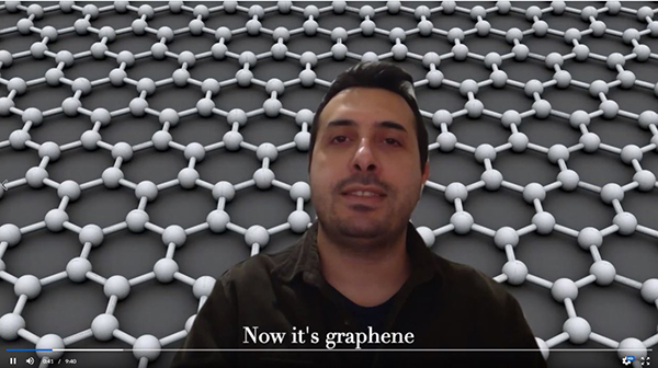 Onur Tosun, an I-MRSEC researcher, sings a verse of the video in front of one of Schleife's visualizations of graphene's honeycomb form