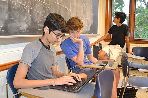 Uni High students Sparsh Singh, Grant Hoey, and Matthew Tang at work doing combinatorics research.