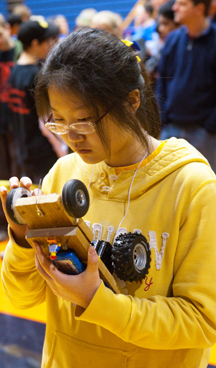 Illinois Science Olympiad contestant examines her project.